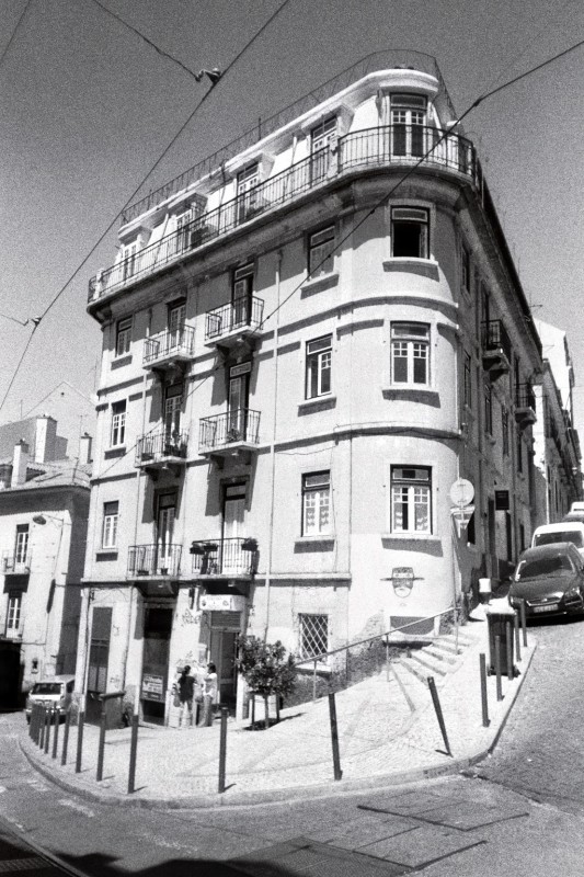 Black & white analogue of a building upon a hill.